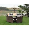 Round PE rattan table & sofas perfectible for relaxing placed near a lake